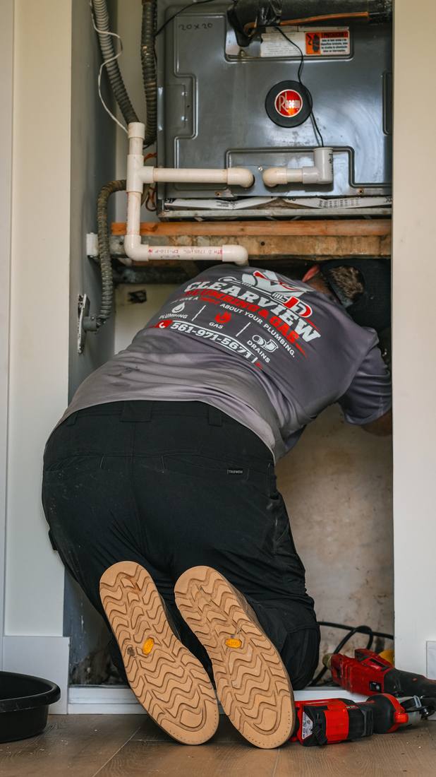 Licensed plumber installing a new water heater in Palm Beach County