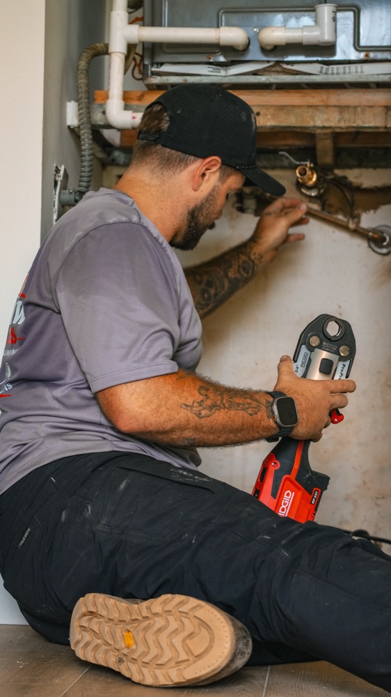 Clearview Plumbing & Gas technician repairing a pipe fitting in a Delray Beach home