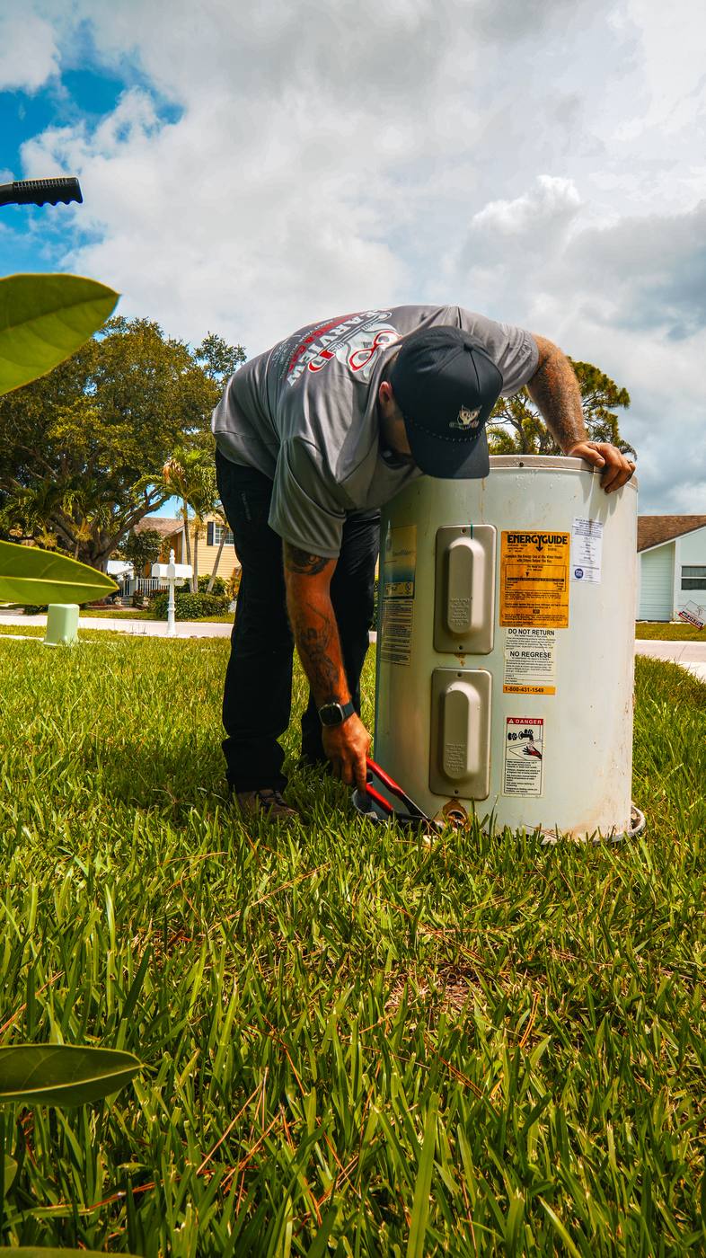 Clearview Plumbing & Gas technician repairing a water heater in a Delray Beach home