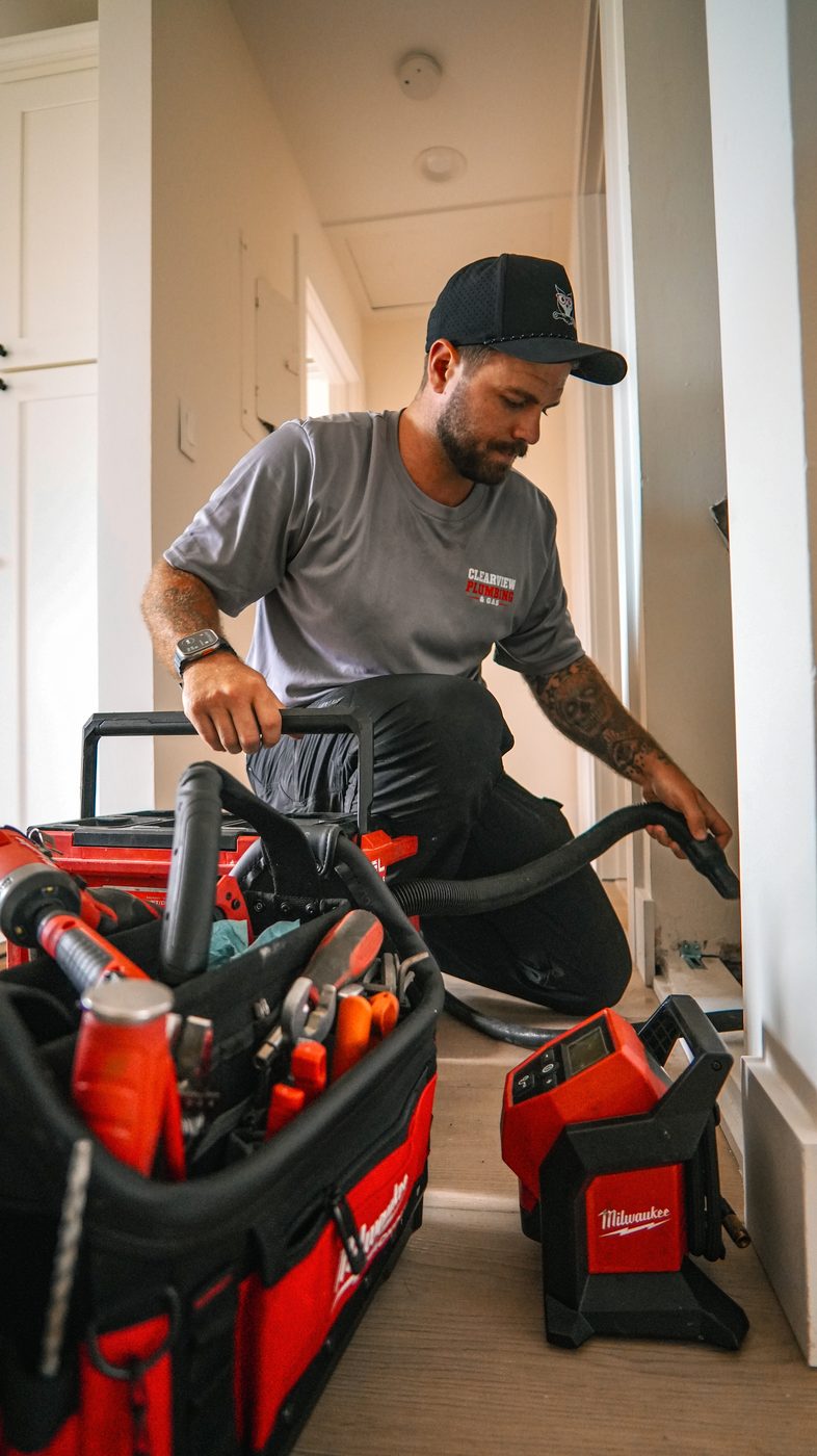 Clearview plumber setting up sewer camera equipment inside a Delray Beach home