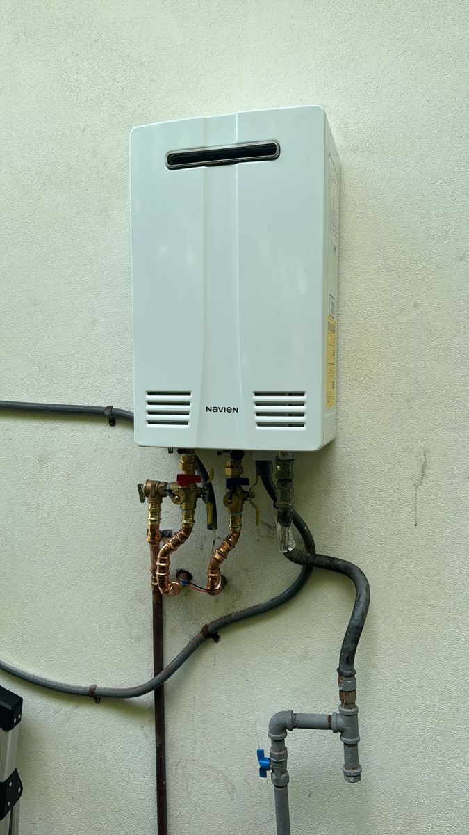 Navien tankless water heater installed on an exterior wall