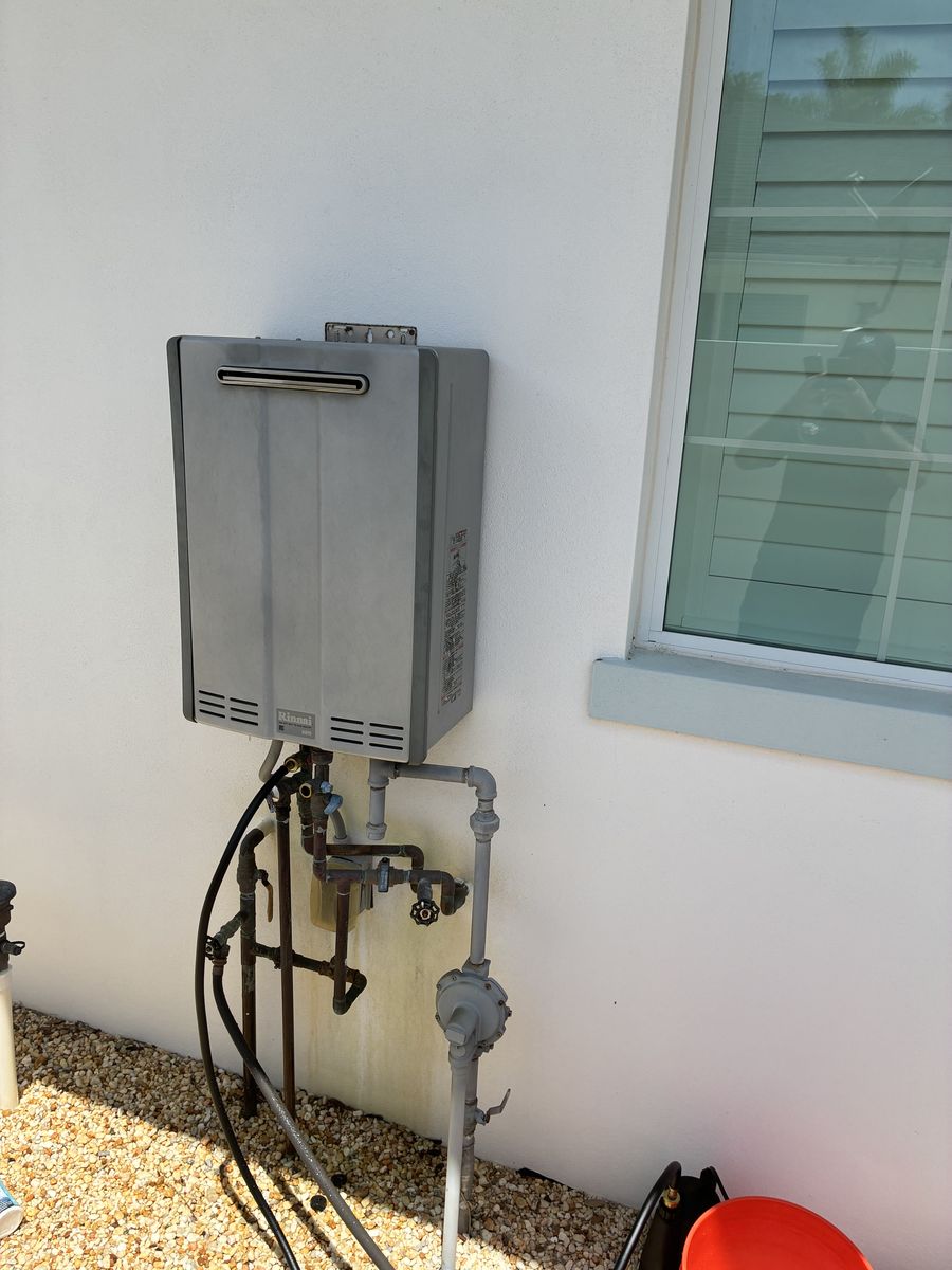Rinnai tankless water heater installed on an exterior wall by Clearview Plumbing & Gas