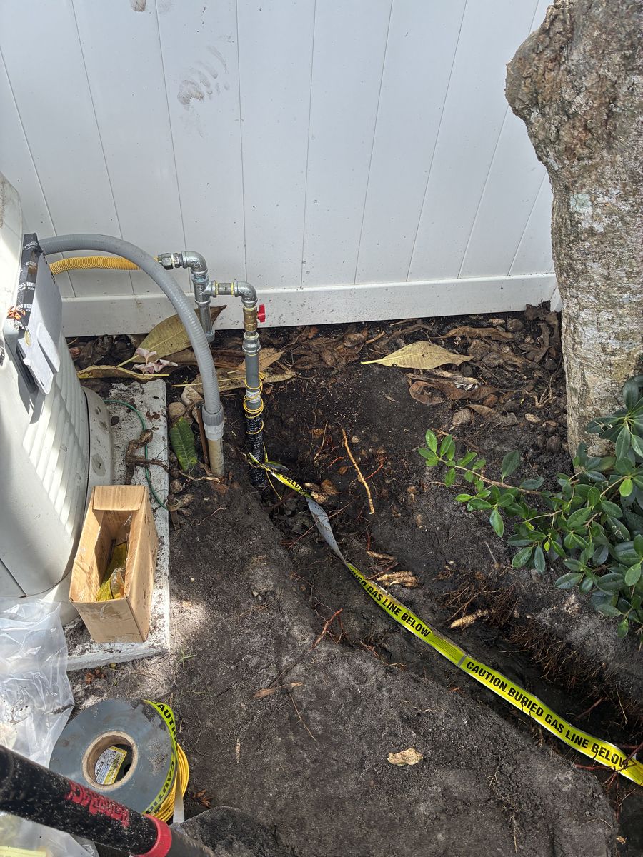 Underground gas line with riser, shutoff valve, and buried gas line warning tape in the trench